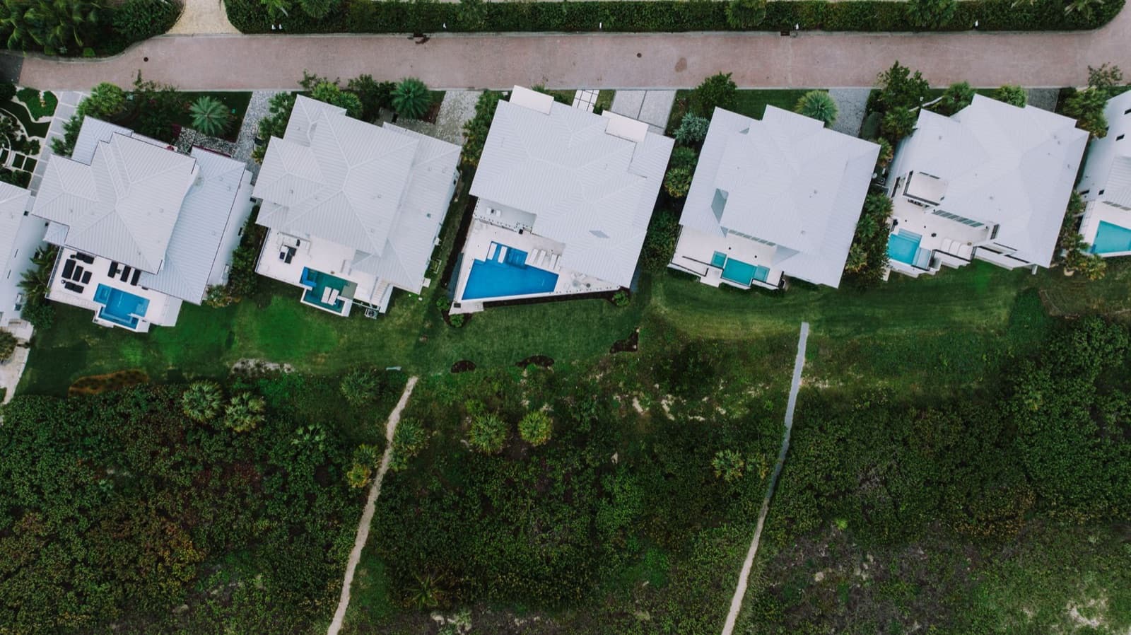Aerial view of a South Florida neighborhood with tile roofs and pools