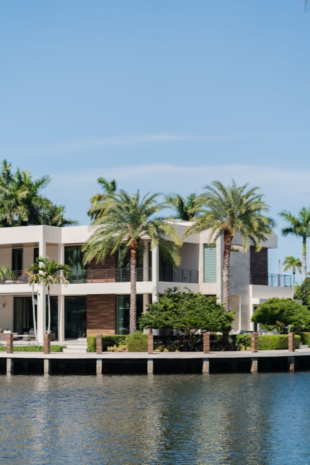 Waterfront South Florida home with palm trees and a new roof