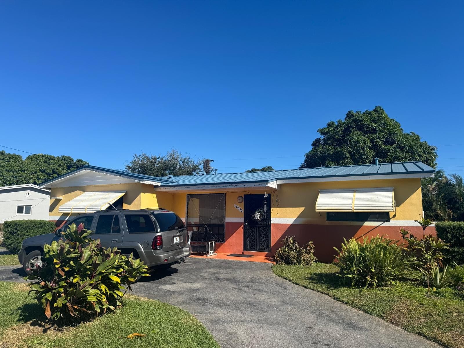 Single-story home with a new standing seam metal roof and fresh exterior paint